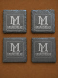 Set of four natural slate coasters laser engraved with the ML Engraving Co logo