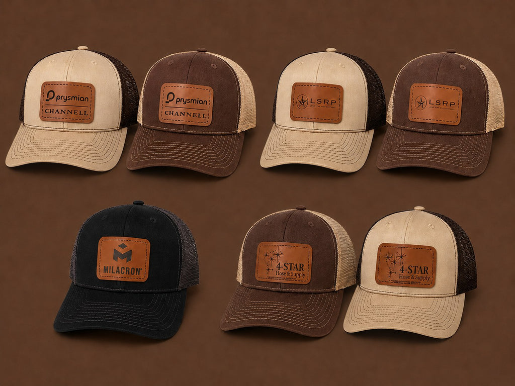Seven leather patch trucker hats in tan, brown and black with engraved customer logos