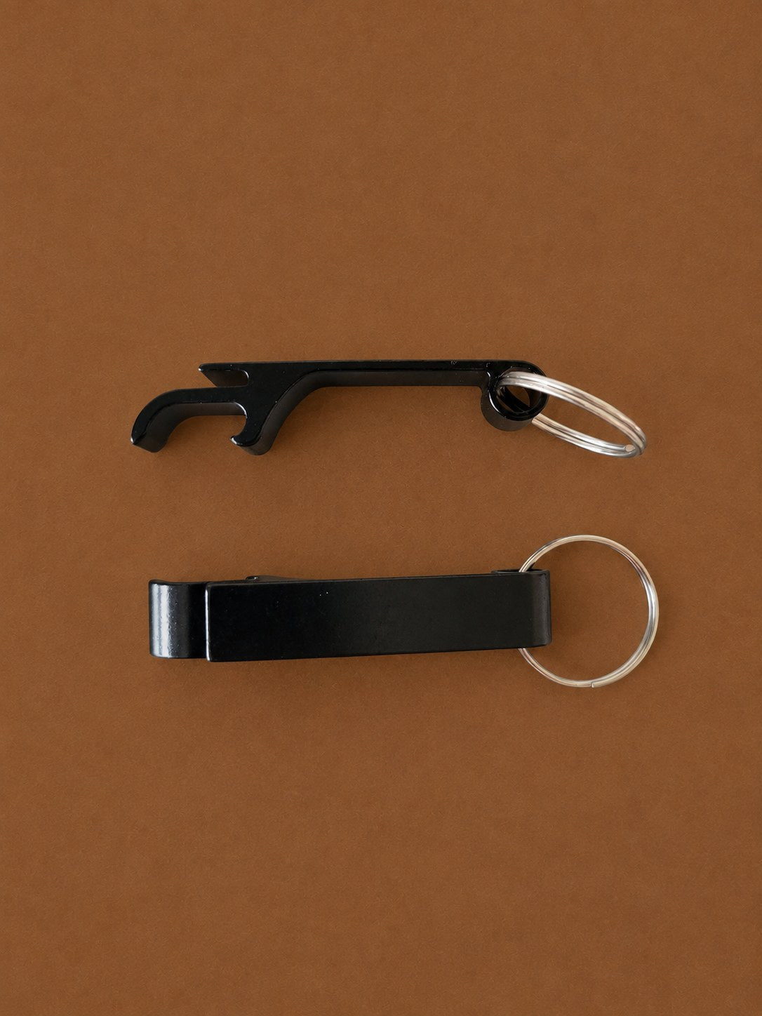 Two black aluminium bottle opener keyrings, front and side